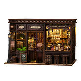 Miniature corner tavern with lit bar, bottles, shelves, and front windows