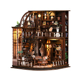 Miniature wooden bookstore dollhouse with lit shelves, arches, and display tables