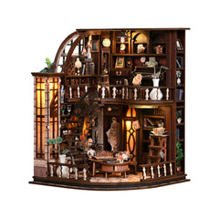 Miniature wooden bookstore dollhouse with lit shelves, arches, and display tables