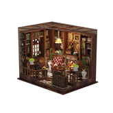 DIY mini house kit with detailed wooden room interior, lamps, and bookshelves