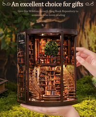 Miniature wooden book repository display with open front door and central leafy tree