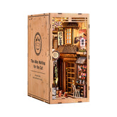 Wooden DIY book nook kit in hinged cabinet packaging with illustrated storefront panel