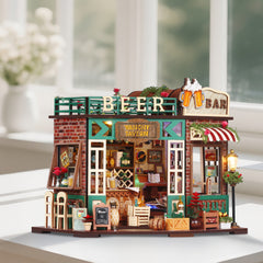 Miniature tavern beer bar dollhouse on a stand with green-framed windows and flower decor