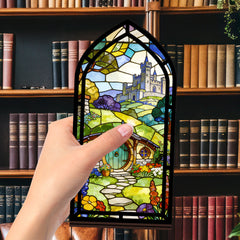 Book nook with stained-glass style panel, held by hand in front of books