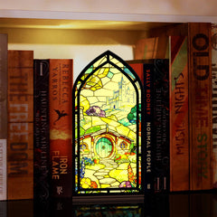 Book nook display with stained-glass style front panel and base on bookshelf
