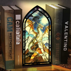 Arched stained-glass dragon book nook stand with black frame and warm candle light