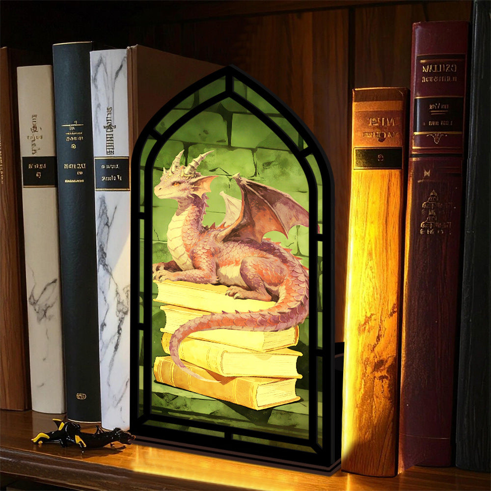 Dragon book nooks display: black arched frame with dragon and stacked books inside