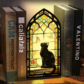Stained glass arched book nook with black cat silhouette and butterfly window glow