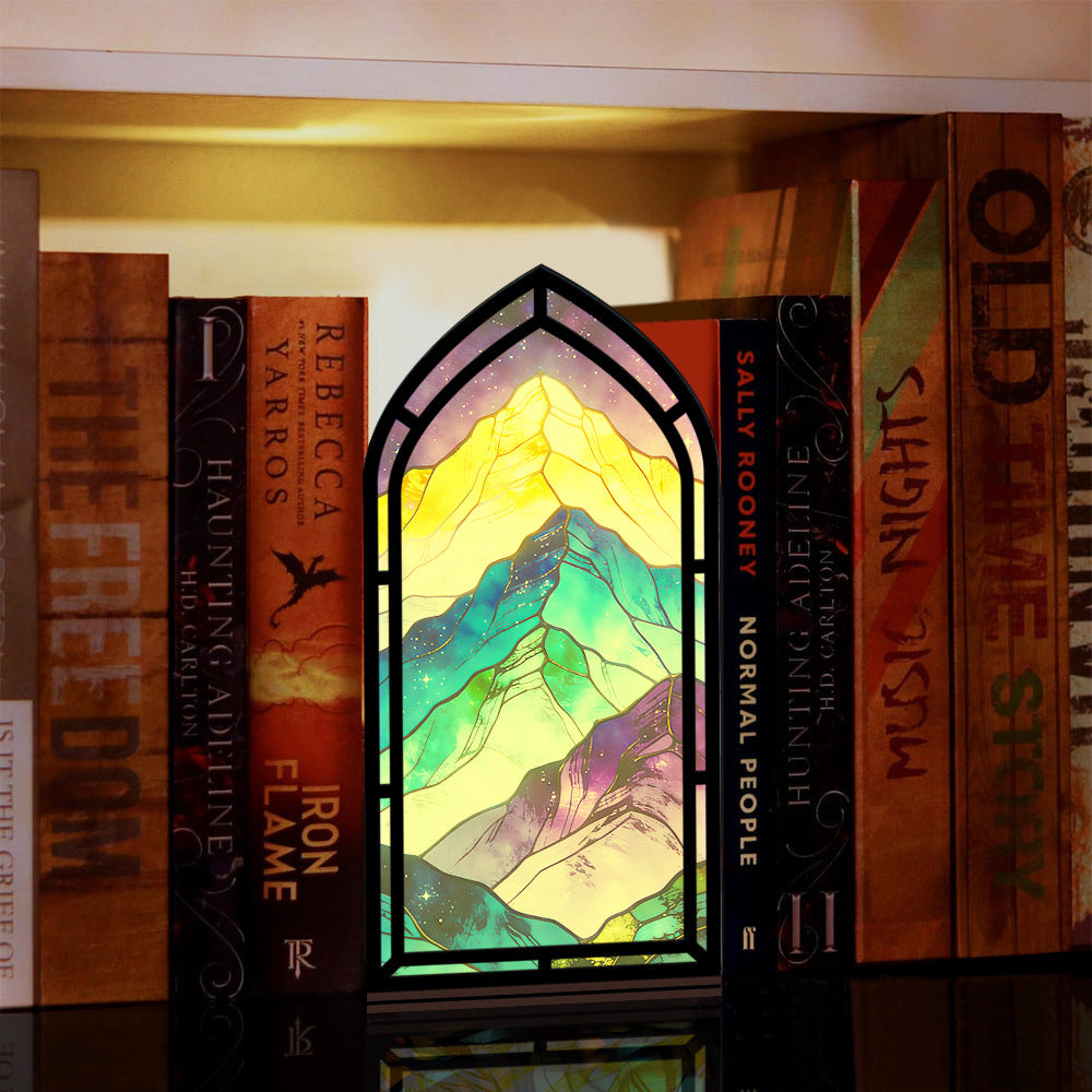 Arched book nook display with glowing rainbow mountain artwork and purple LED border