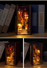 Miniature book nook kit with door panels open, showing illuminated night market shops and food displays