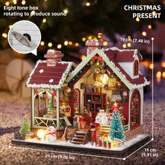 Cozy Christmas miniature dollhouse with lit room, red shutters, and decorated yard