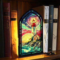 Coastal lighthouse book nook with stained-glass lighthouse window and warm candle light
