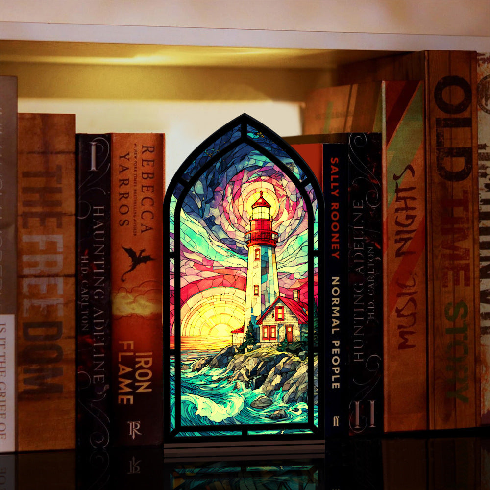Coastal lighthouse book nook with stained-glass scene and glowing candle