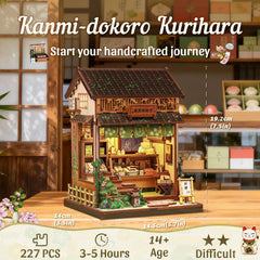 Miniature wooden shop building with green awnings, open front, and warm interior display