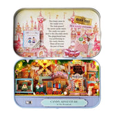 Miniature candy shop diorama inside an open metal case with colorful toy houses