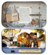 Snowy winter diorama tin box with miniature hotel and trees inside