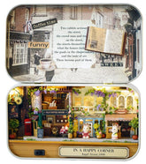 Box theater diorama with open lid showing mini street text and detailed shopfront scene
