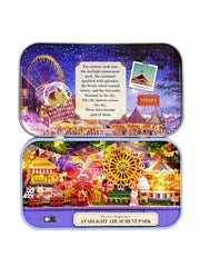 Mini amusement park diorama in a blue metal tin with colorful illuminated rides and Ferris wheel