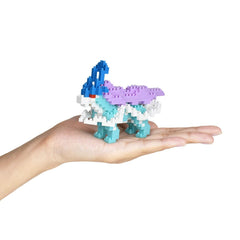 A hand holding a small, colorful, and intricate toy made of small, colorful building blocks.