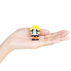A hand holding a small, colorful, pixelated figure of a character with yellow hair and a black outfit.