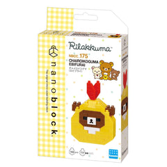 The image is a packaging box for a product called "Rilakuma" that is a type of building block. The box features a yellow and white checkered pattern and includes a picture of the product, which is a yellow and brown bear-shaped building block.