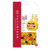 The image is a packaging for a product called "DARUMA YELLOW" from the "nano-lock" brand. The packaging features a close-up of the product itself, which is a yellow block with a face on it, along with the product's name and other information.