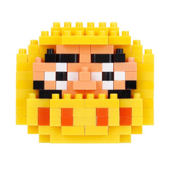 A colorful, pixelated face made up of yellow and orange blocks, resembling a pixelated character or design.