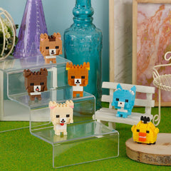 A collection of small, colorful, pixelated animal figurines displayed on a glass shelf, with a blue bottle and other decorative items in the background.