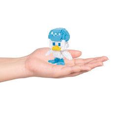 A hand holding a small, colorful, pixelated toy figure of a duck.