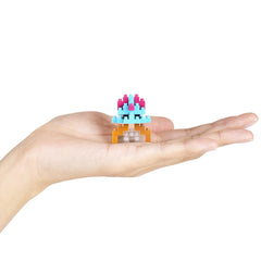 A hand holding a small, colorful, and intricate toy or model.