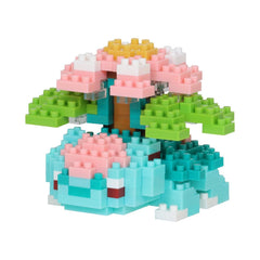 A colorful toy made of small building blocks in various shades of pink, green, blue, and yellow.