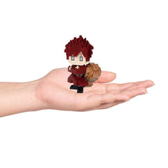 A hand holding a small, red-haired, cartoon-like figure.