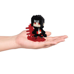 A hand holding a small, black and red figurine made of small, red and black building blocks.