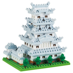 A white, multi-tiered building made of small, white and gray building blocks, resembling a castle or palace.