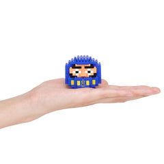 A hand holding a small blue and yellow pixelated character or toy.
