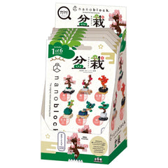 The image is a box containing a set of six different tree-themed building blocks, each with a unique design. The box is predominantly white and green, with various images of the tree blocks displayed on the packaging.