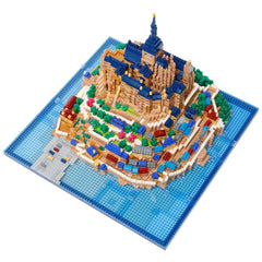A detailed model of a castle or palace, constructed from colorful building blocks, displayed on a blue base.