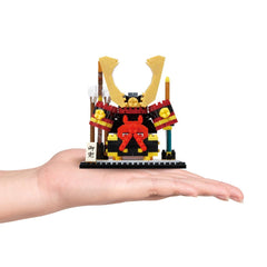 Samurai helmet nano block model on display base, red and black with gold arms