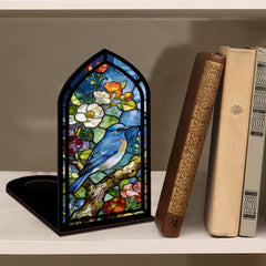 Arched stained-glass book nook with bluebird scene and black base, on tabletop