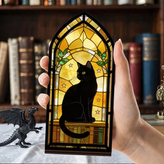 Handheld arched black cat book nook with warm glowing window