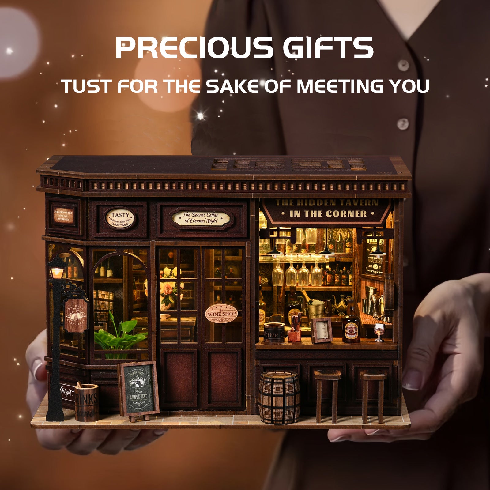 A miniature model of a bar or pub, with a person holding it in their hands.