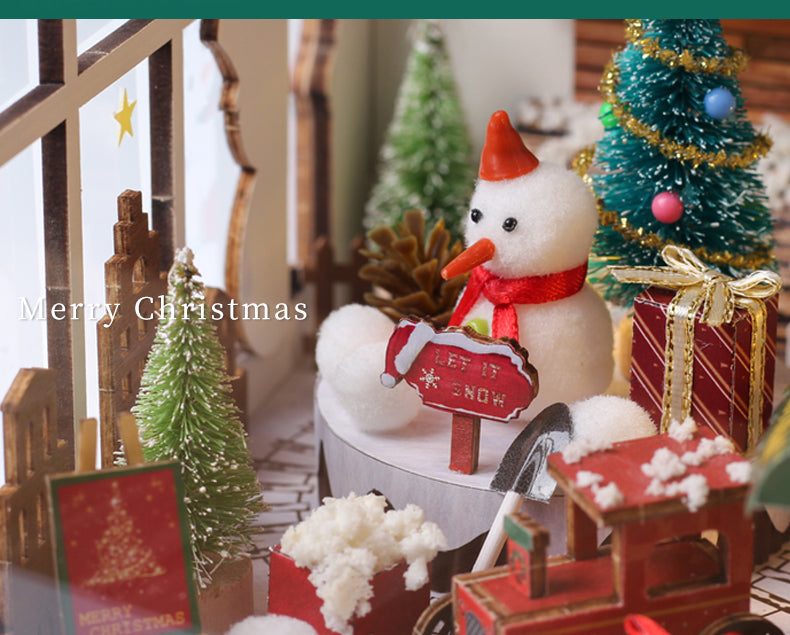 Miniature Christmas book nook shelf insert with snowman figure, Christmas trees, and tiny gifts
