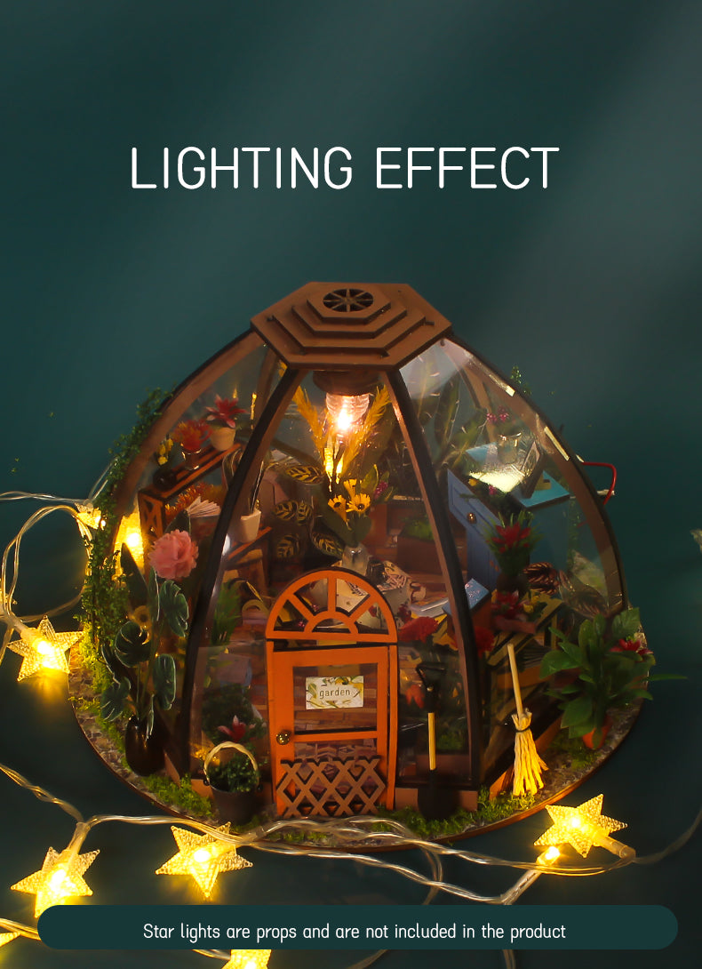 Domed greenhouse miniature house kit with warm light bulbs and glowing string stars.