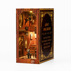 Book nook kit box with open doorway view showing a lit interior and ornate gold trim