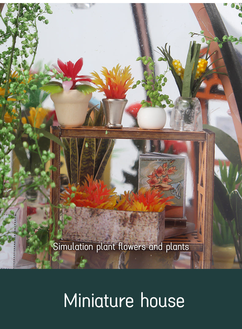 Miniature greenhouse interior shelf with potted plants, flowers, and decorative items.