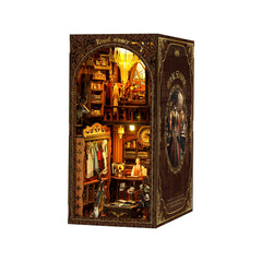 DIY book nook kit showing a lit miniature room interior with arched shelves