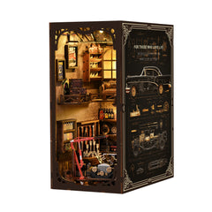 Miniature workshop diorama kit with dark hinged case, open view with shelves and tools