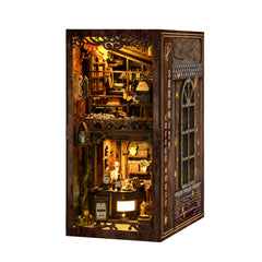 DIY book nook kit showing a miniature dark wood coffee house interior with lit shelves