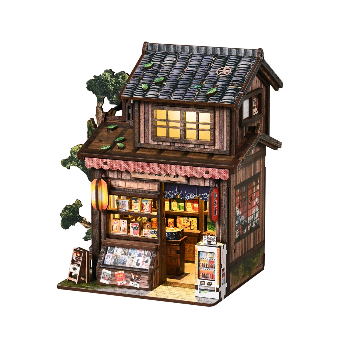 Miniature wooden Japanese grocery store model with lit windows, tiled roof, and shelves