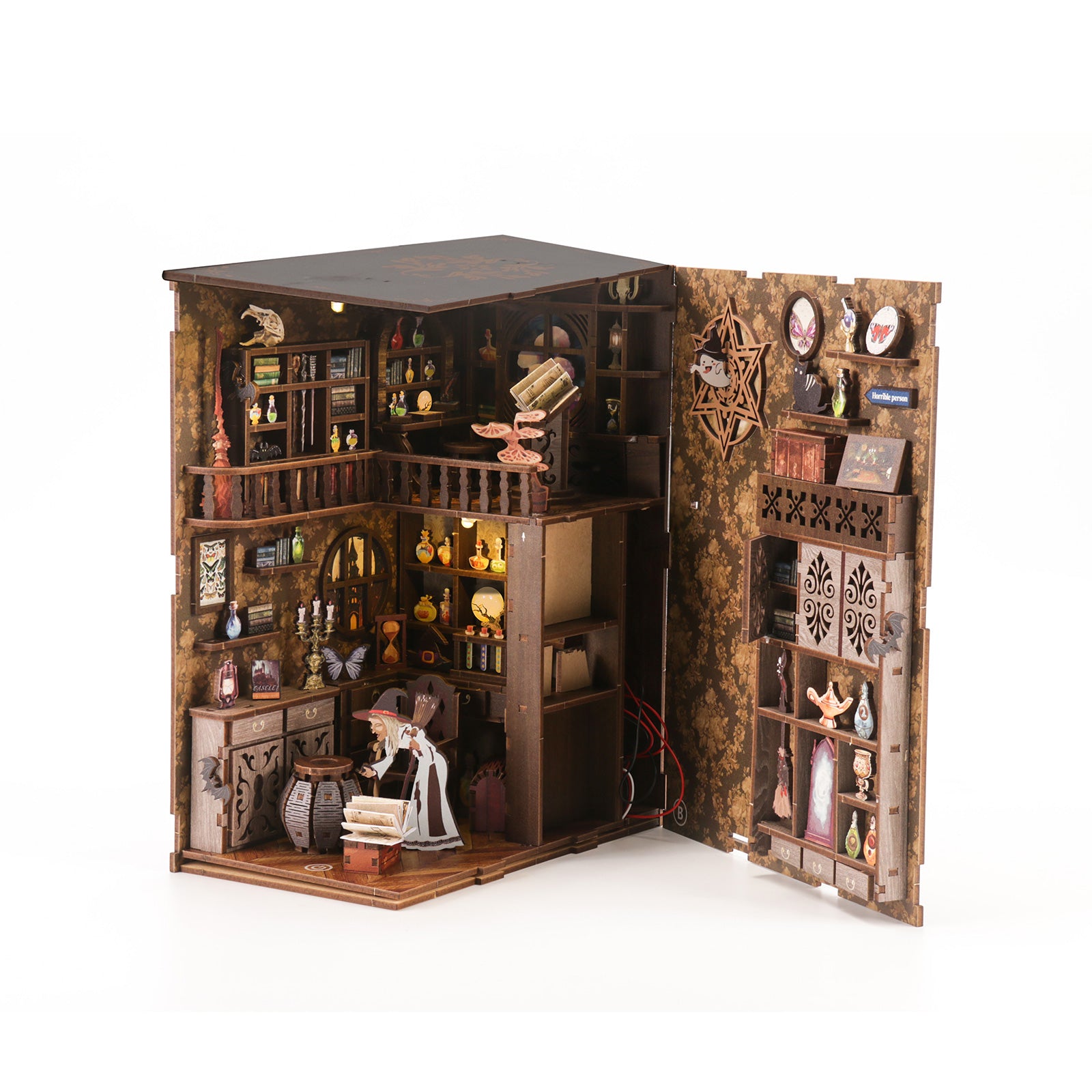 DIY book nook kit in wooden cabinet with miniature rooms, shelves, and figurines